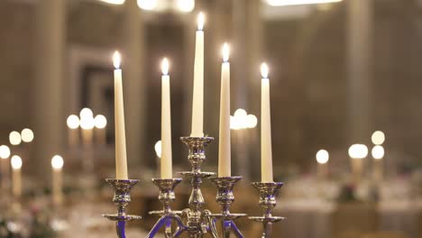 candelabra with lit candles creating a warm, elegant ambiance in a softly lit room