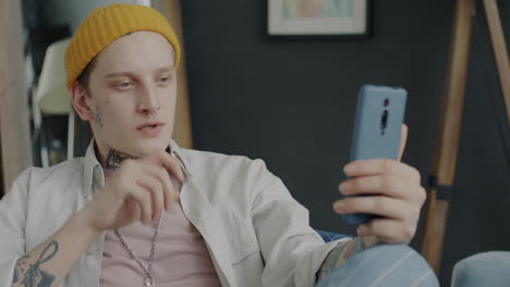 young man using smartphone in conversation