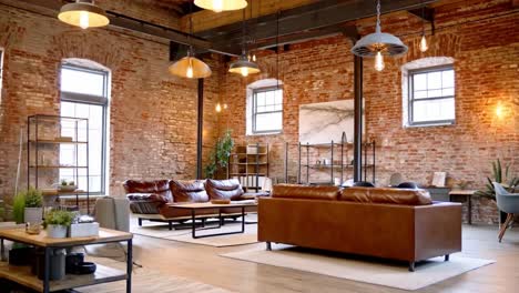 spacious loft living room with exposed brick and leather sofas