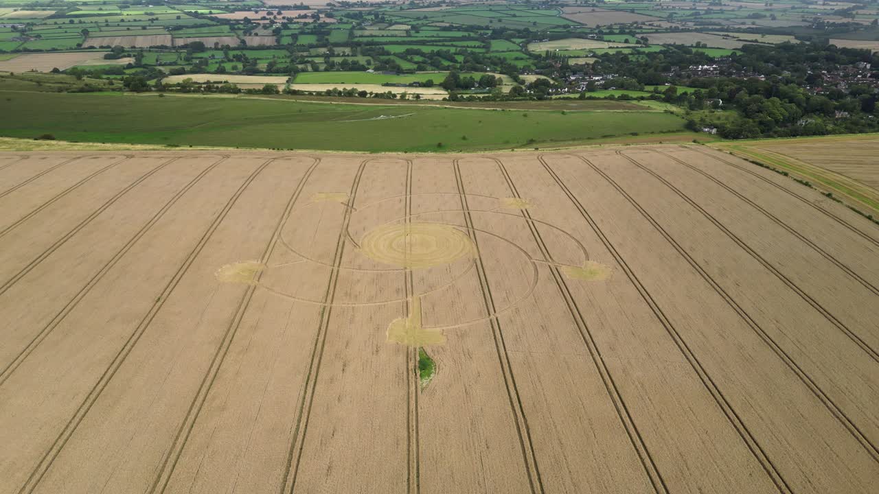 Combe hill crop circle intricate spiral pattern aerial view circling idyllic Wiltshire agricultural wheat field