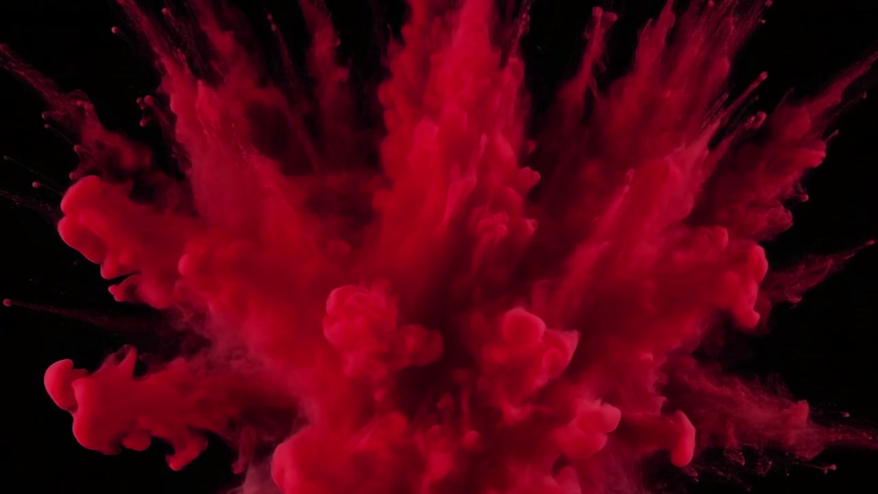 Vibrant Red Powder Explosion Against a Black Background