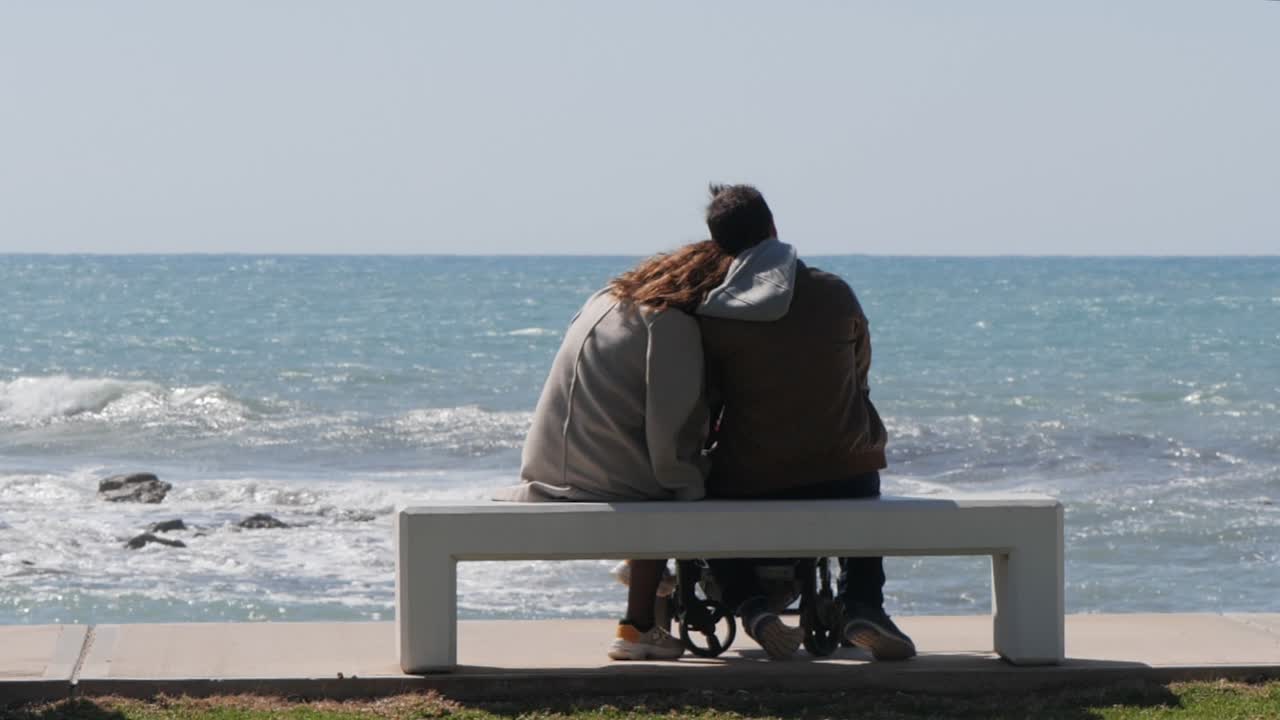 Slow Motion Shot Of Young Couple Enjoying The View At The Beach On A Sunny Day