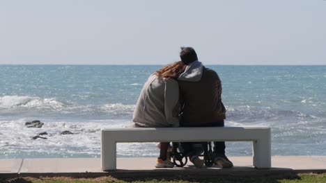 slow motion shot of young couple enjoying the view at the beach on a sunny day