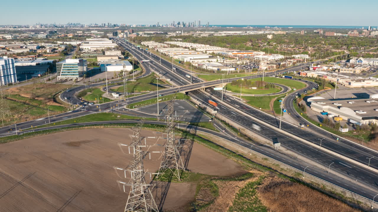 A highway overpass and interchange on highway 401 in mississauga, canada, captured in a hyperlapse, aerial view