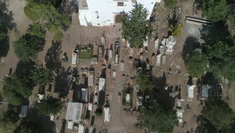 aerial tilt down shot of a cemetery and a church in real de catorce