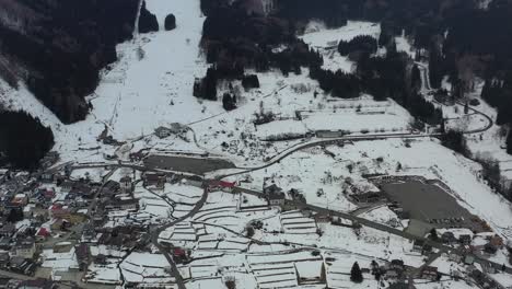 base-of-the-mountain-ski-resort-in-nozawa-onsen-nagano-japan-with-little-snow-in-winter,-aerial