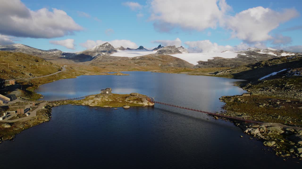 Drone time lapse of a mountain lake surrounded by mountain landscape nature and a glacier. Norway 4K