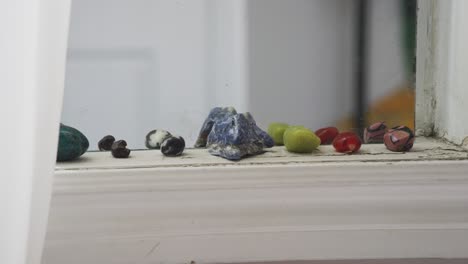 colorful crystals lined up on a window sill