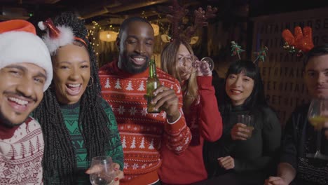 POV-Shot-of-Friends-Talking-into-Mobile-Phone-During-Christmas-Video-Call