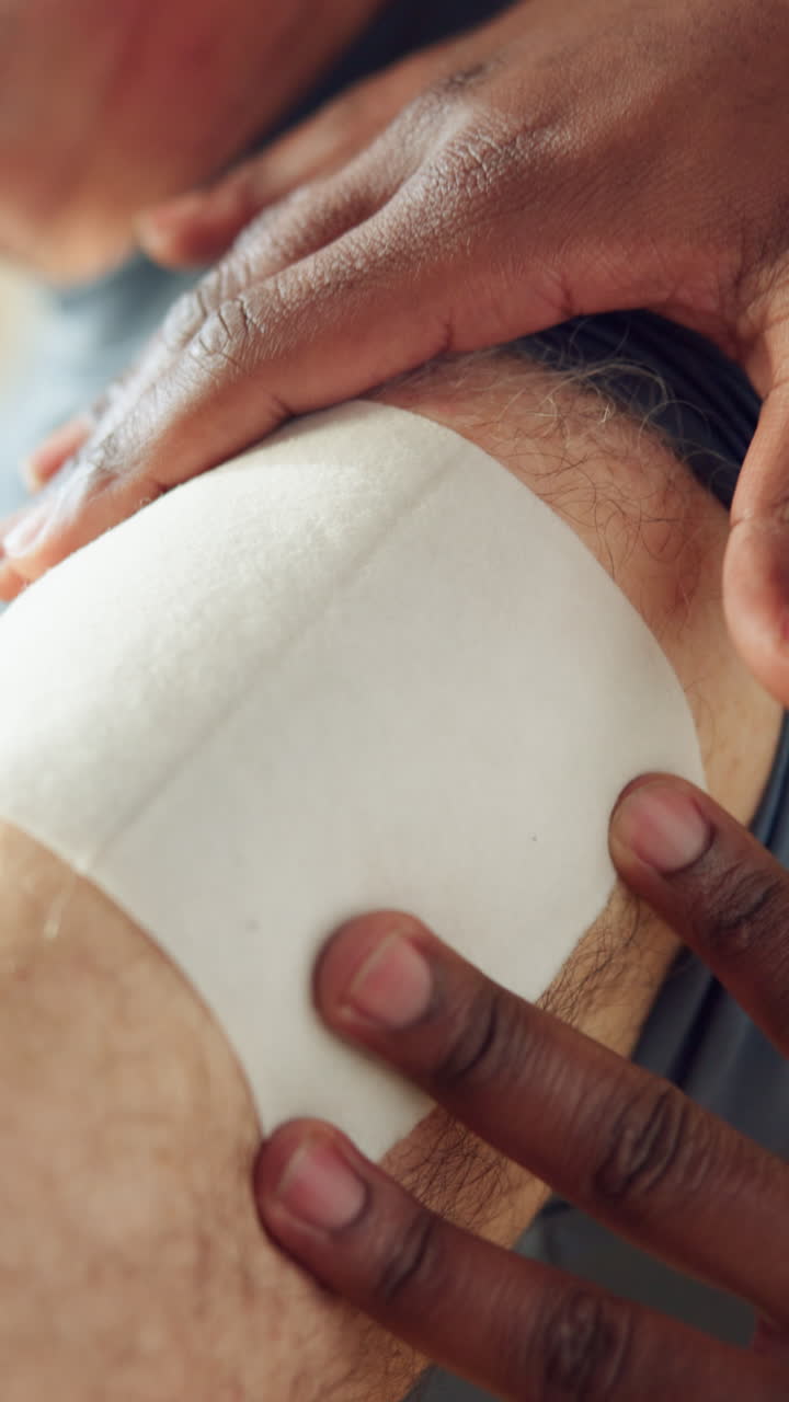 Close-Up of Man's Arm with Medical Patch Covered by Sleeve