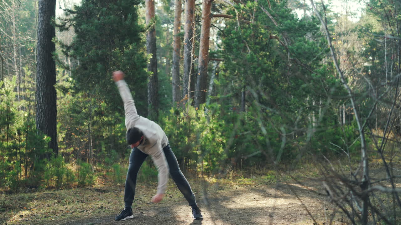 Man Stretching in a Forest