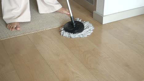 woman mopping a wooden floor