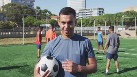 efecto de clic del obturador de la cámara contra contra el retrato de un jugador de fútbol masculino sosteniendo una pelota de fútbol
