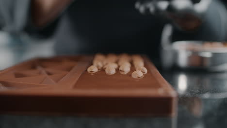making chocolate bar with almonds