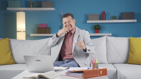 home office worker man has tooth sensitivity.