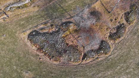 Aerial-Shot-Of-A-Agricultural-Farm-Field-With-Stone-Piles-In-Rural-Smaland,-Sweden