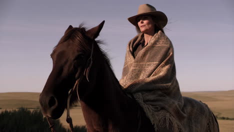 woman riding a horse in a rural landscape