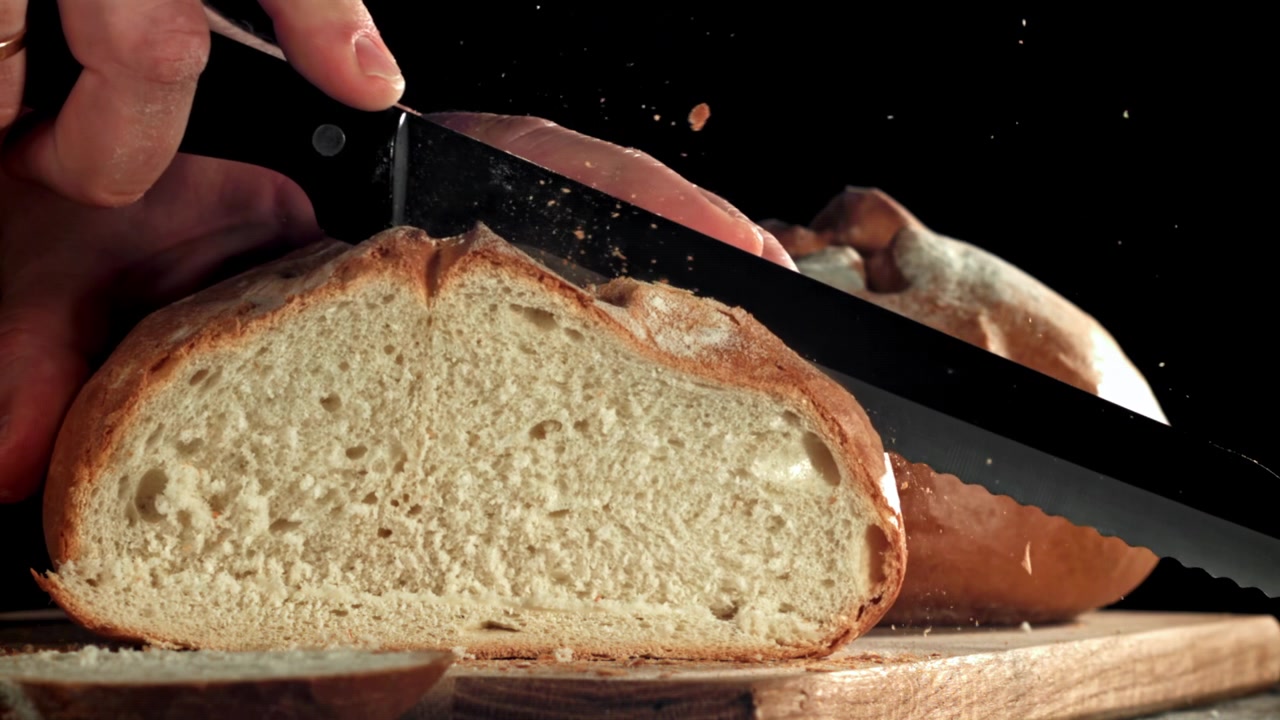 Super Slow Motion of Slicing Freshly Baked Bread with a Knife
