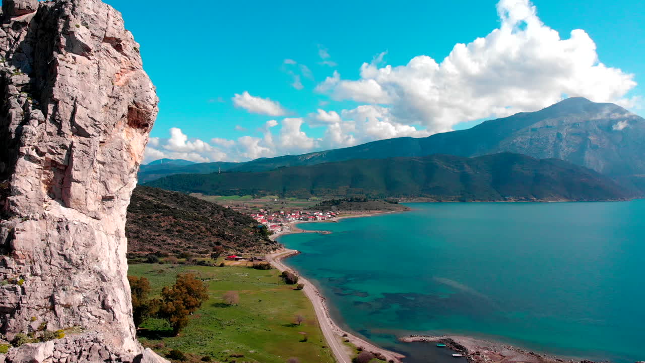 Rocky Cliff Of Mountain Reveal The Beautiful And Calm Blue Ocean And Bright Blue Sky In Greece - slow panning shot