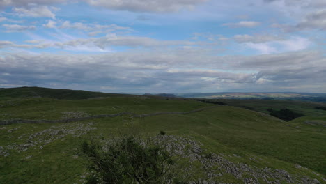 aerial-flight-forwards-and-up-over-a-lone-ash-tree-growing-in-limestone-pavement