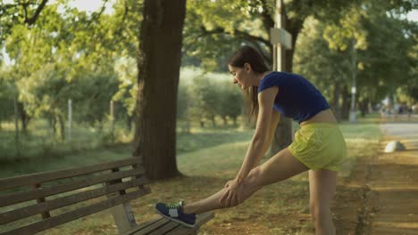 fitness woman runner stretching legs before run