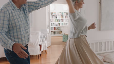 happy mature couple dancing at home enjoying romantic dance together celebrating relationship milestone having peaceful retirement 4k