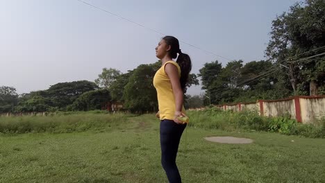teenage young asian girl practicing skipping rope at playground at morning, slow motion