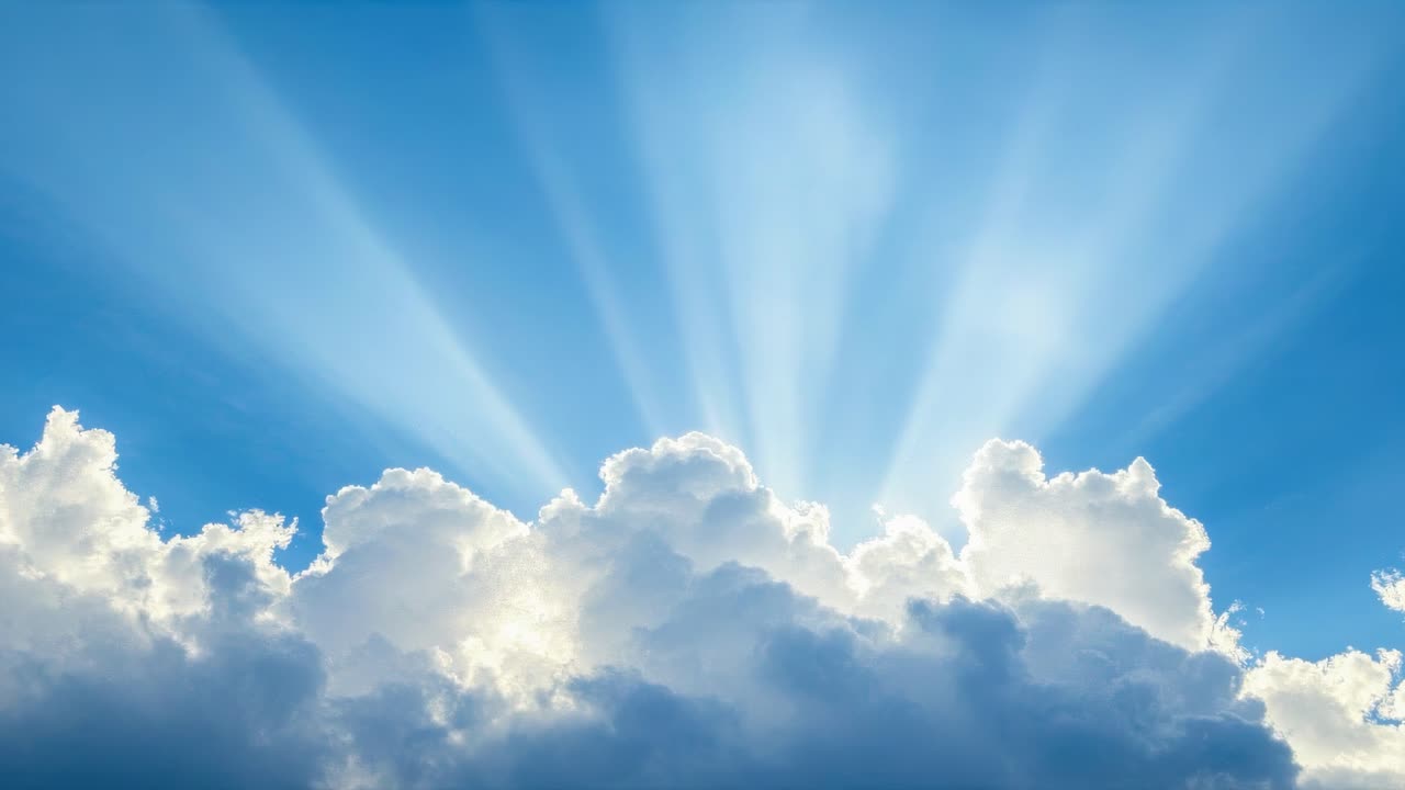 A serene video concept of sun rays streaming through fluffy clouds