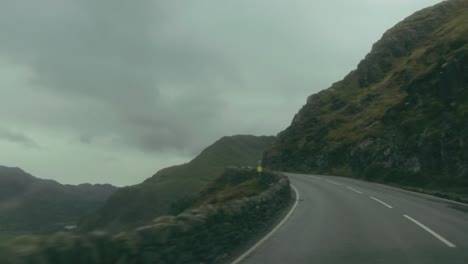 pov on the road through a mountain pass, snowdonia, wales, uk
