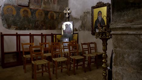 interior of old small church with wall hagiographies and saint images, cinematic moody shot