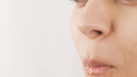 Close-up-portrait-of-woman-eating-broccoli.-Eating-healthy.