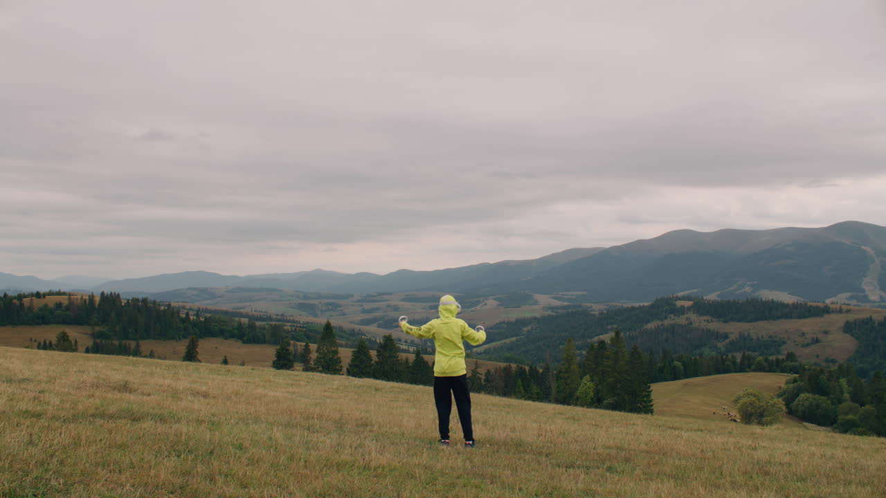 Person with VR Headset on Mountaintop