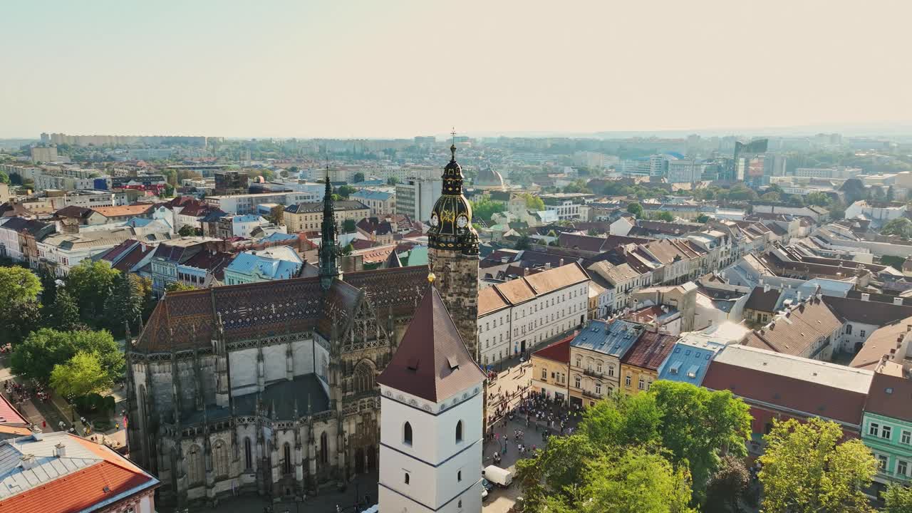 Breathtaking aerial view of Kosice, Slovakia, showcasing the city's historic cathedral, surrounded by a mix of modern and old architecture, highlighting the rich cultural heritage of the city. (4K)