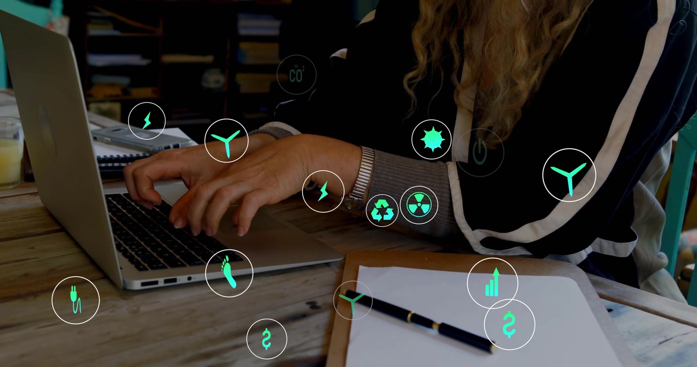 Mature woman typing on laptop, reviewing energy data, causing green icons rising and orbiting hands