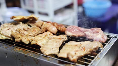 grilling sausages and pork at a street market