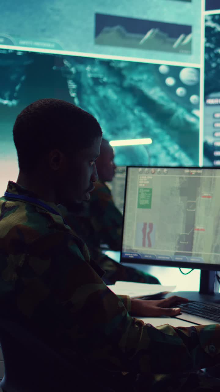 African American Soldier Working on Computer in Military Control Room