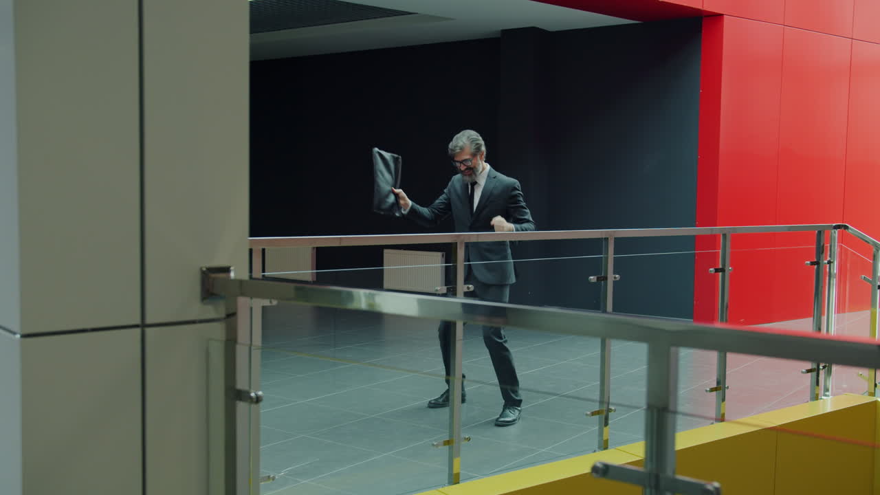 Businessman celebrating in office corridor