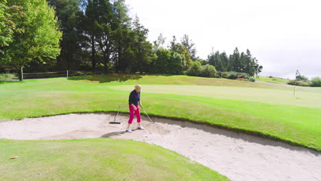 golf players playing golf and knocking golf ball out on golf course on cloudy day