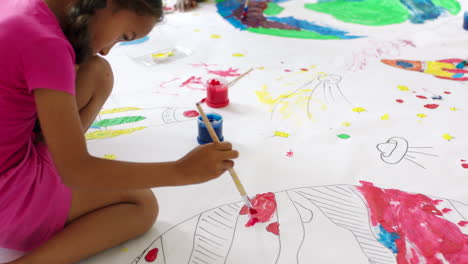 children painting on large paper