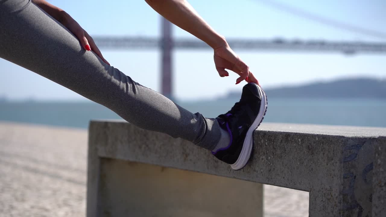 Cropped shot of girl stretching leg outdoor