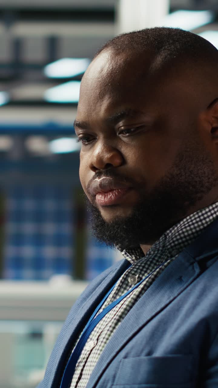 Vertical video Cheerful photovoltaics plant specialist works on innovative breakthroughs