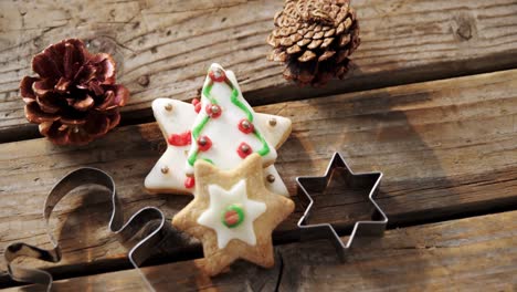 christmas cookies and cookie cutters on wooden table 4k