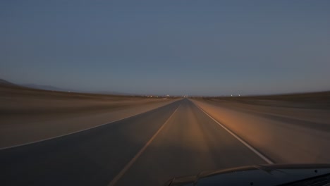 driving at night along a two-lane highway passing cars leaving light trails - point of view motion hyper lapse