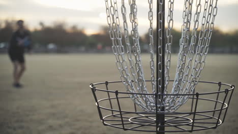 Disc-Golfer-Barely-Makes-a-Putt-with-Blue-Frisbee