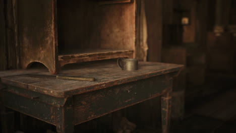 vintage wooden table with an old cup and dusty pencil in a dimly lit room