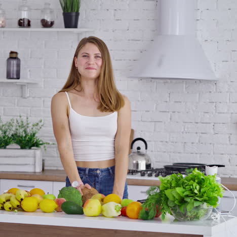 beautiful woman with coconut after shopping. young lady holding a fresh fruit and smiling on the kitchen background. fresh fruits and vegetables on the table. healthy food concept.