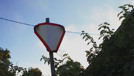 the giveaway sign stands in the village near the house on a sunny day in the morning on the edge of the road