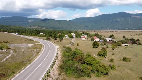 touring bus driving the road to plitvice national park, croatia - aerial drone view of inland with green valley and farms