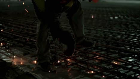 industrial professional worker is cutting metal rebar with a circular saw. construction of a factory, hangar