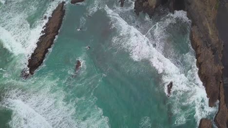 Birds-eye-view-of-rocks-and-cliffs-at-Karekare-Beach-in-New-Zealand